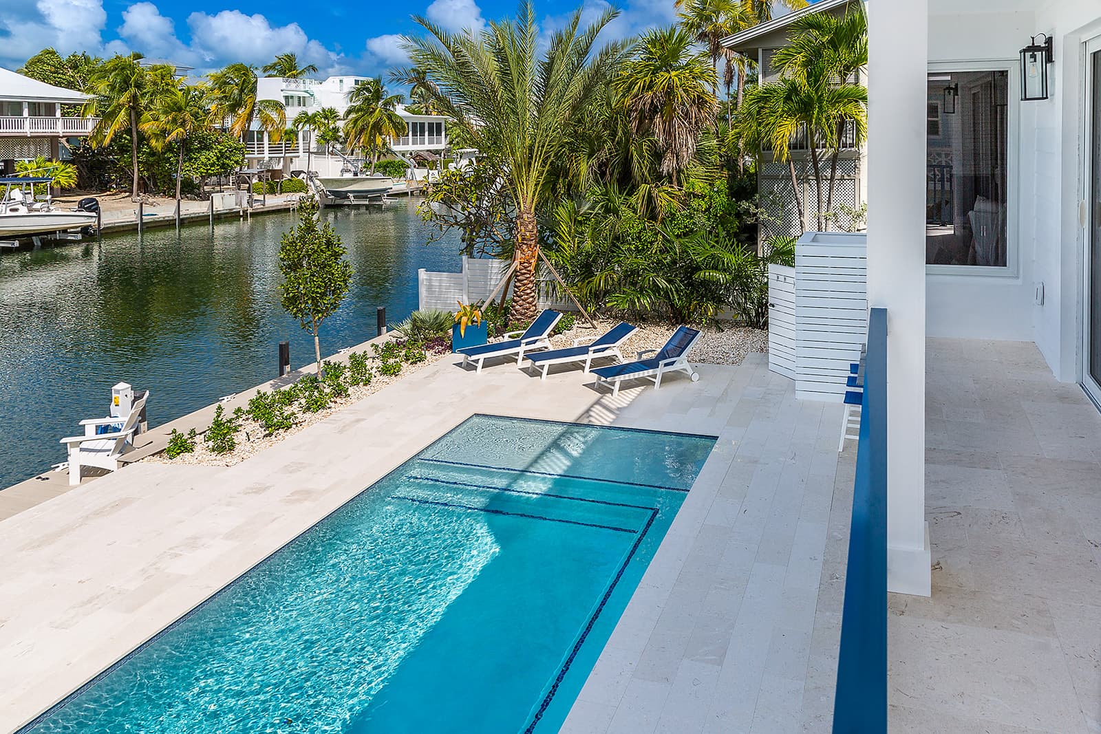 Canal view, pool, and covered lounge