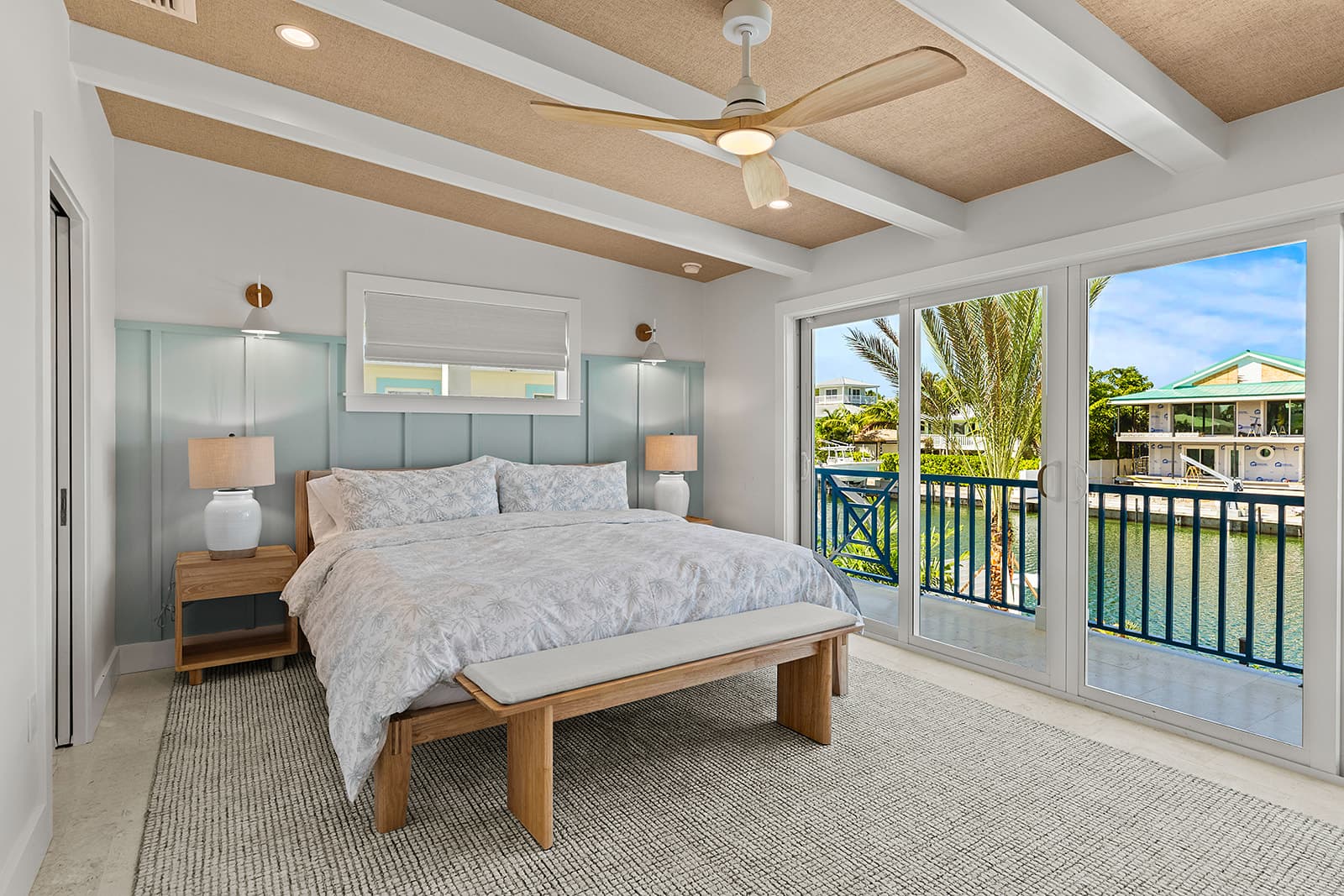 Wet bar, living area, and primary bedroom with water view