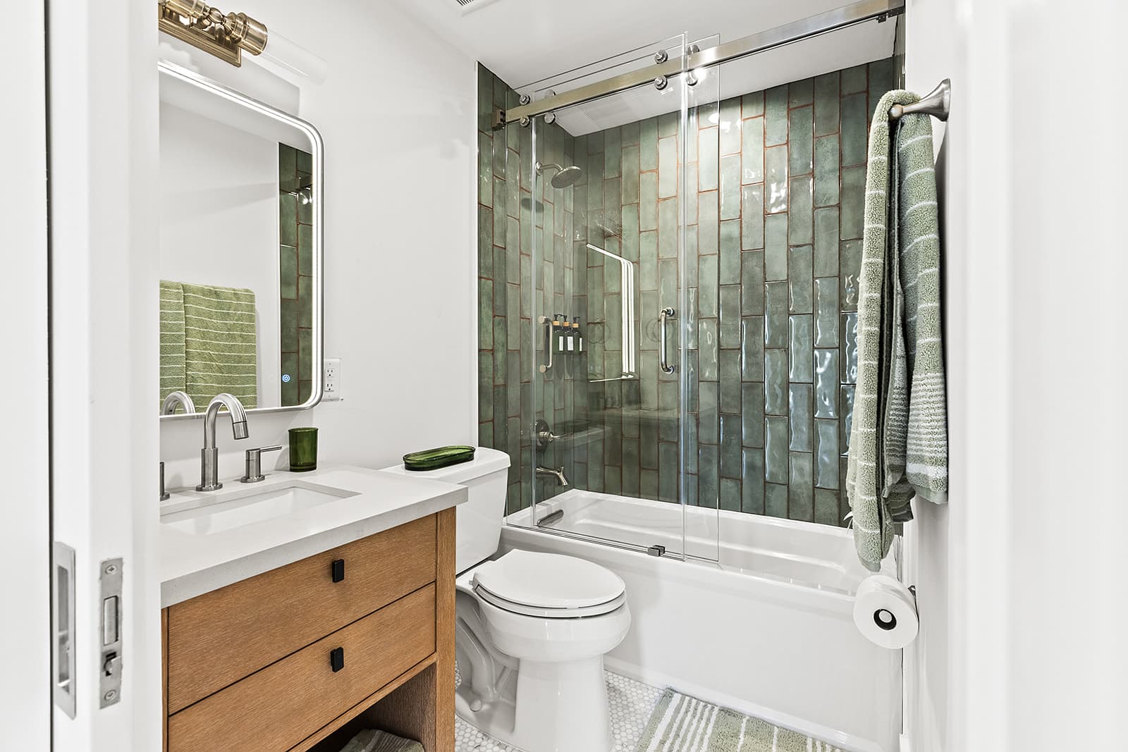 Wet bar, living area, and primary bedroom with water view